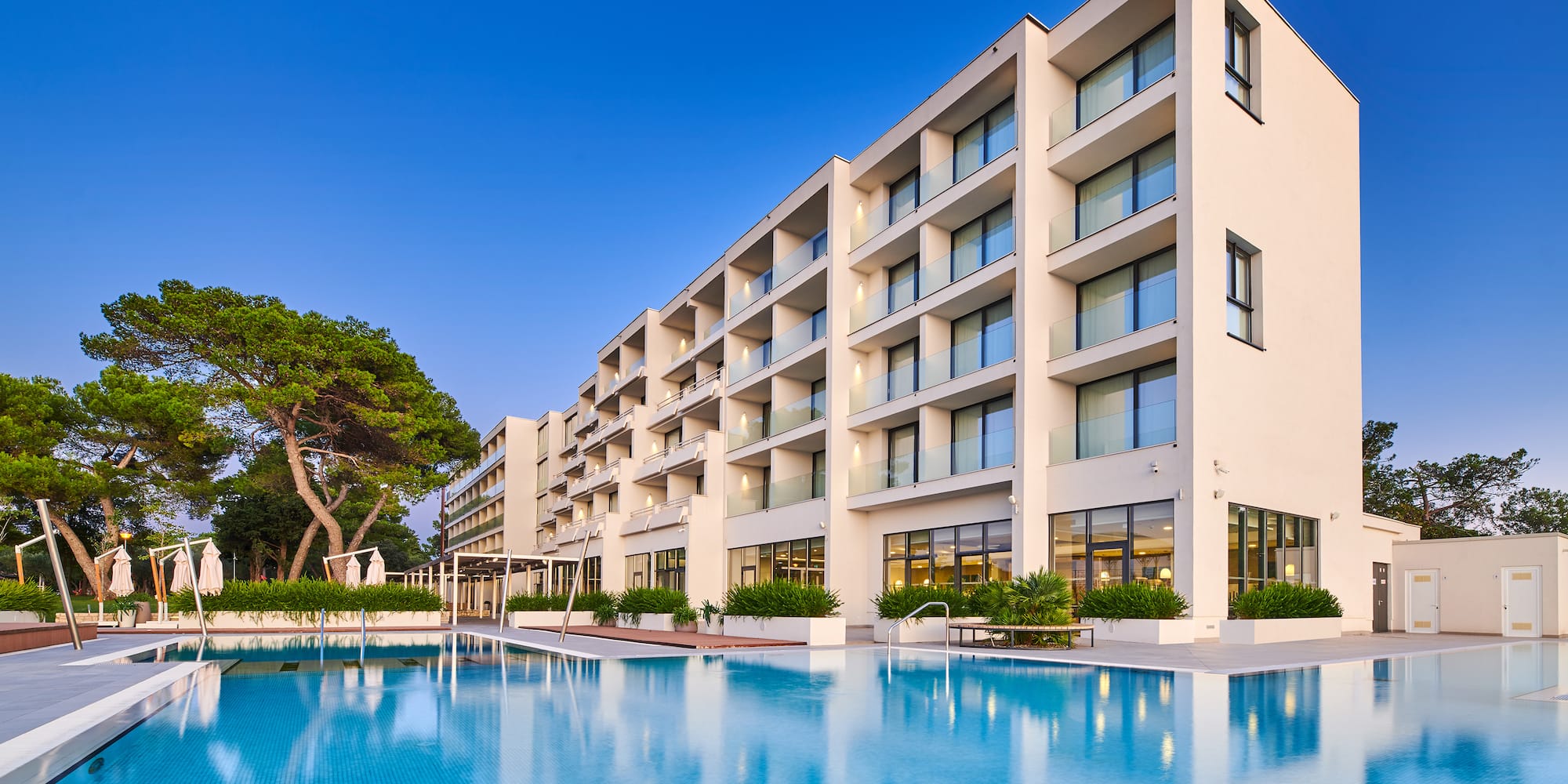 a large building with a pool in front of it