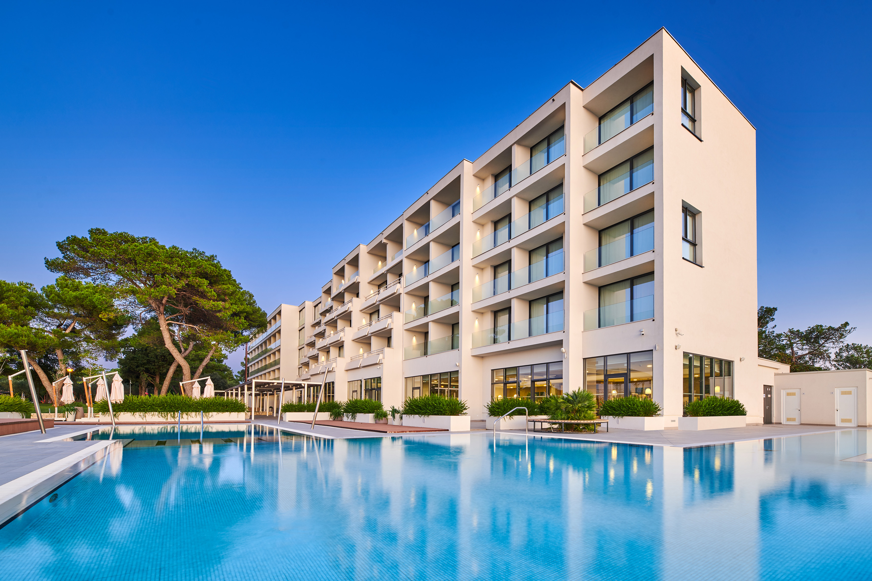 a large building with a pool in front of it