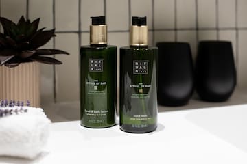 a couple of green bottles on a white counter