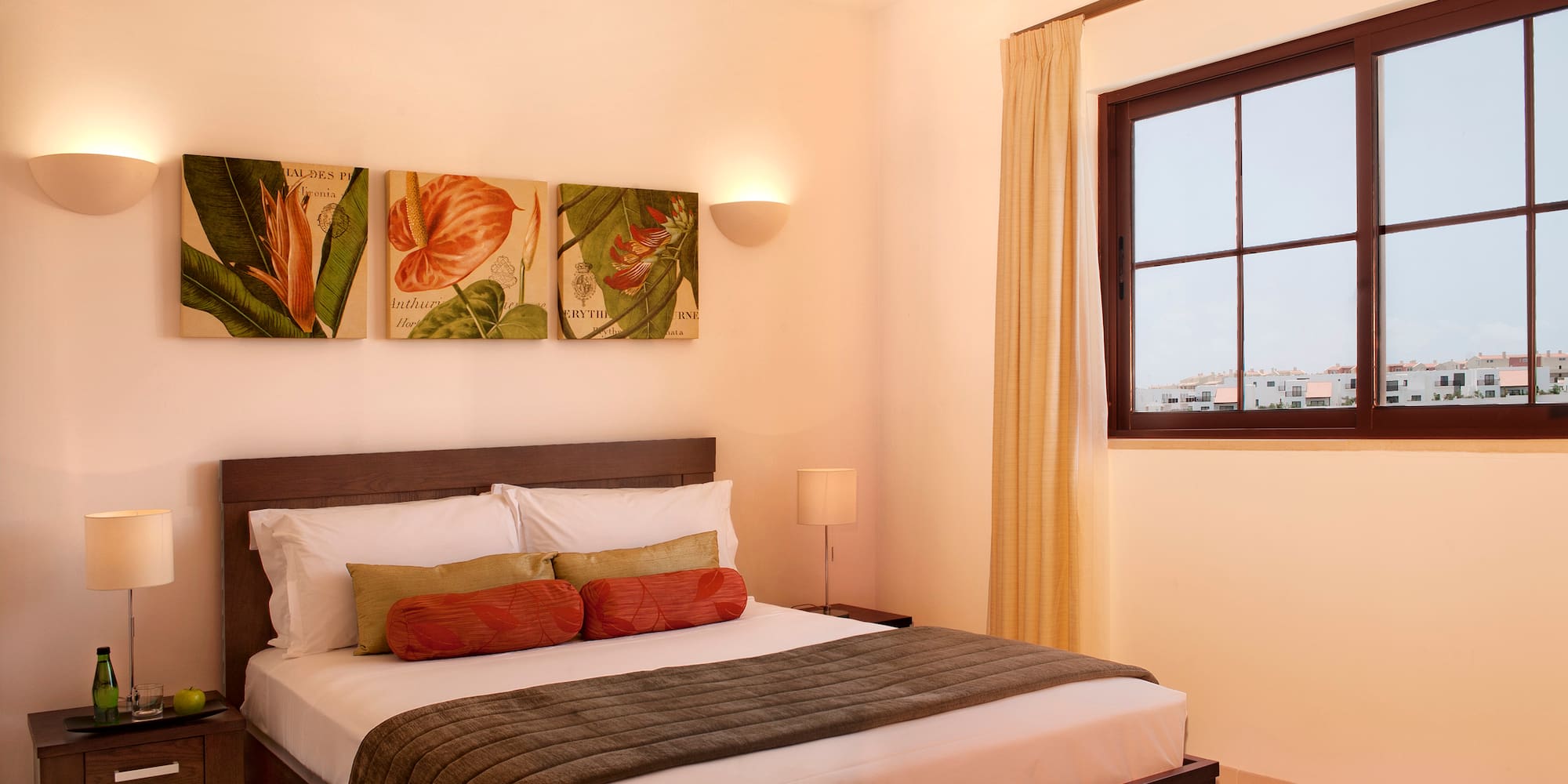 a bed with pillows and a window