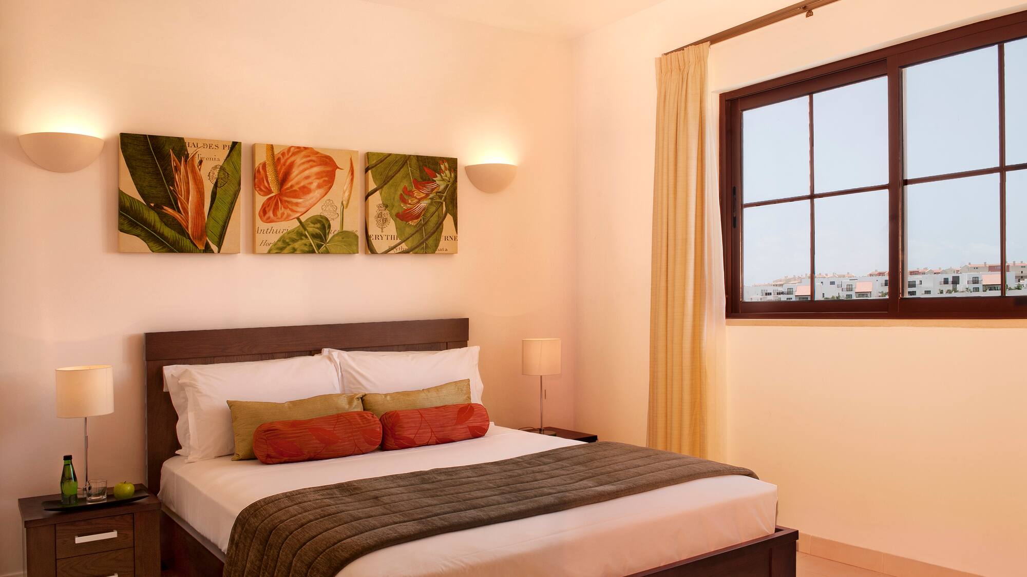 a bed with pillows and a window