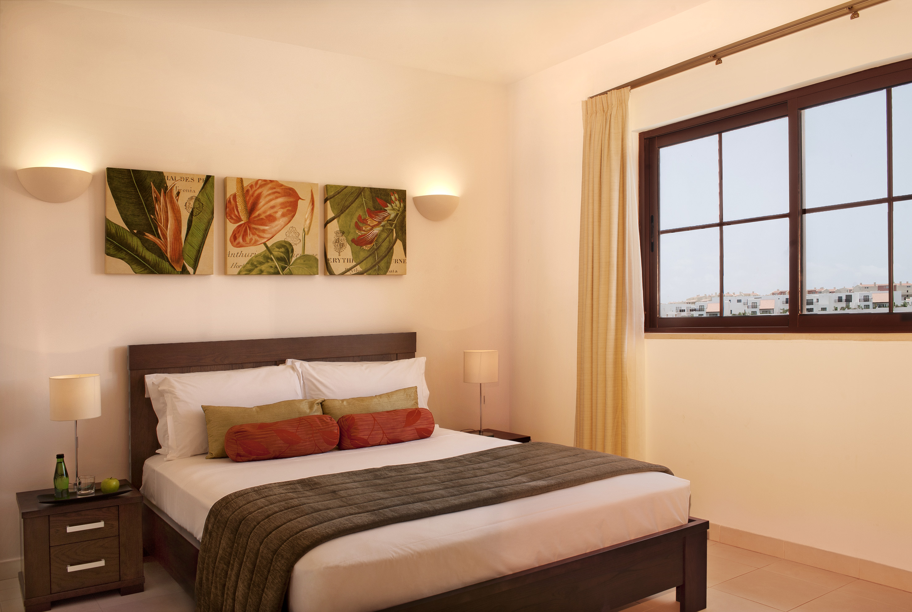 a bed with pillows and a window