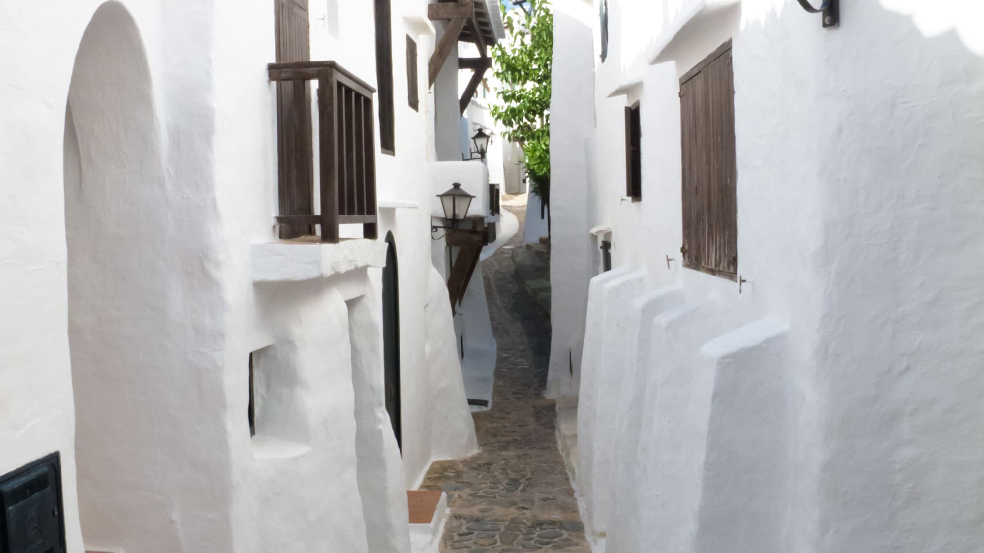 a narrow street with white buildings