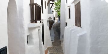 a narrow street with white buildings
