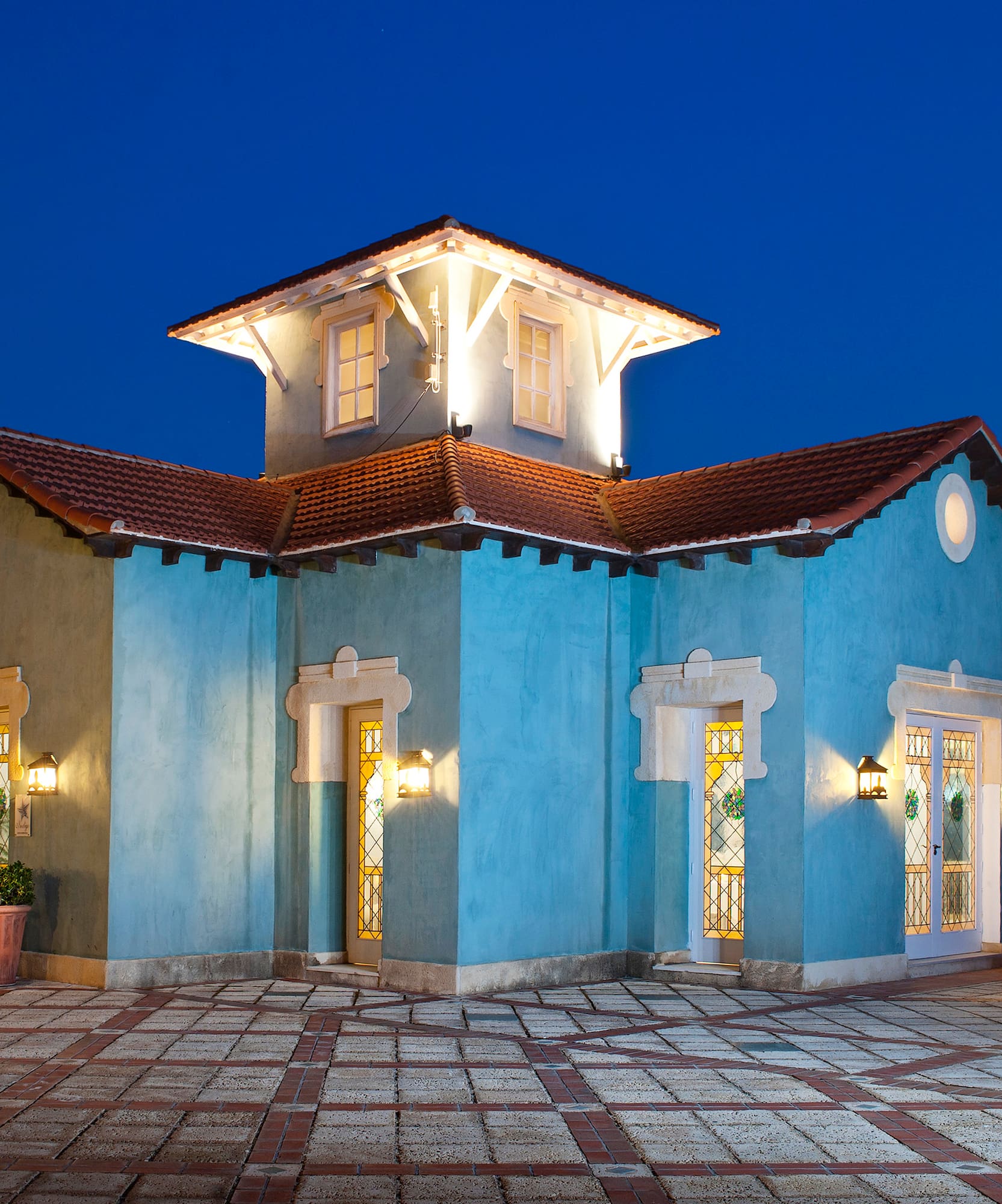 a blue house with lights on the outside