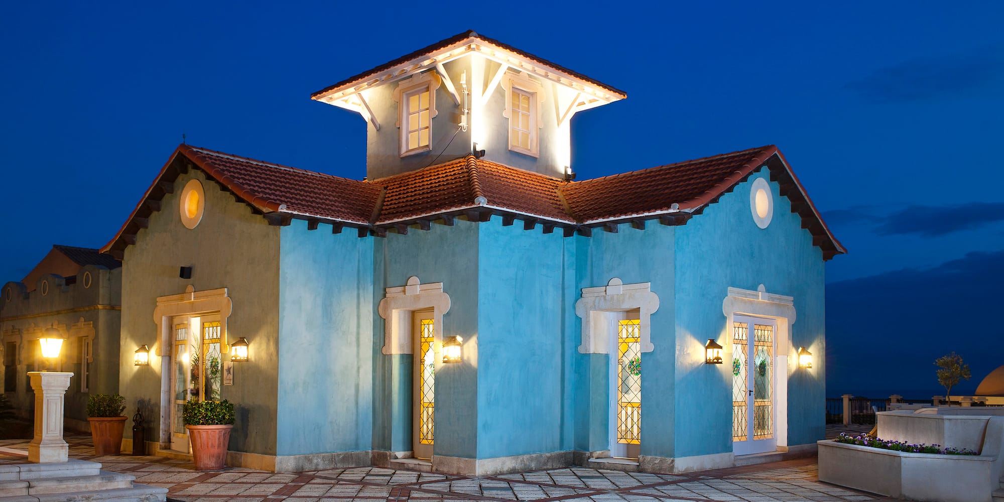 a blue house with lights on the outside