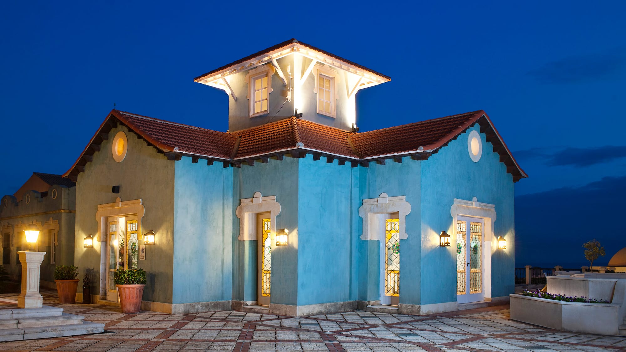 a blue house with lights on the outside