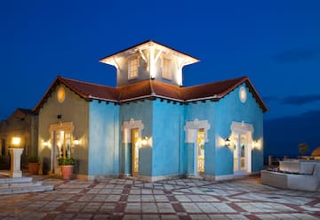 a blue house with lights on the outside