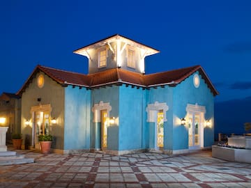 a blue house with lights on the outside