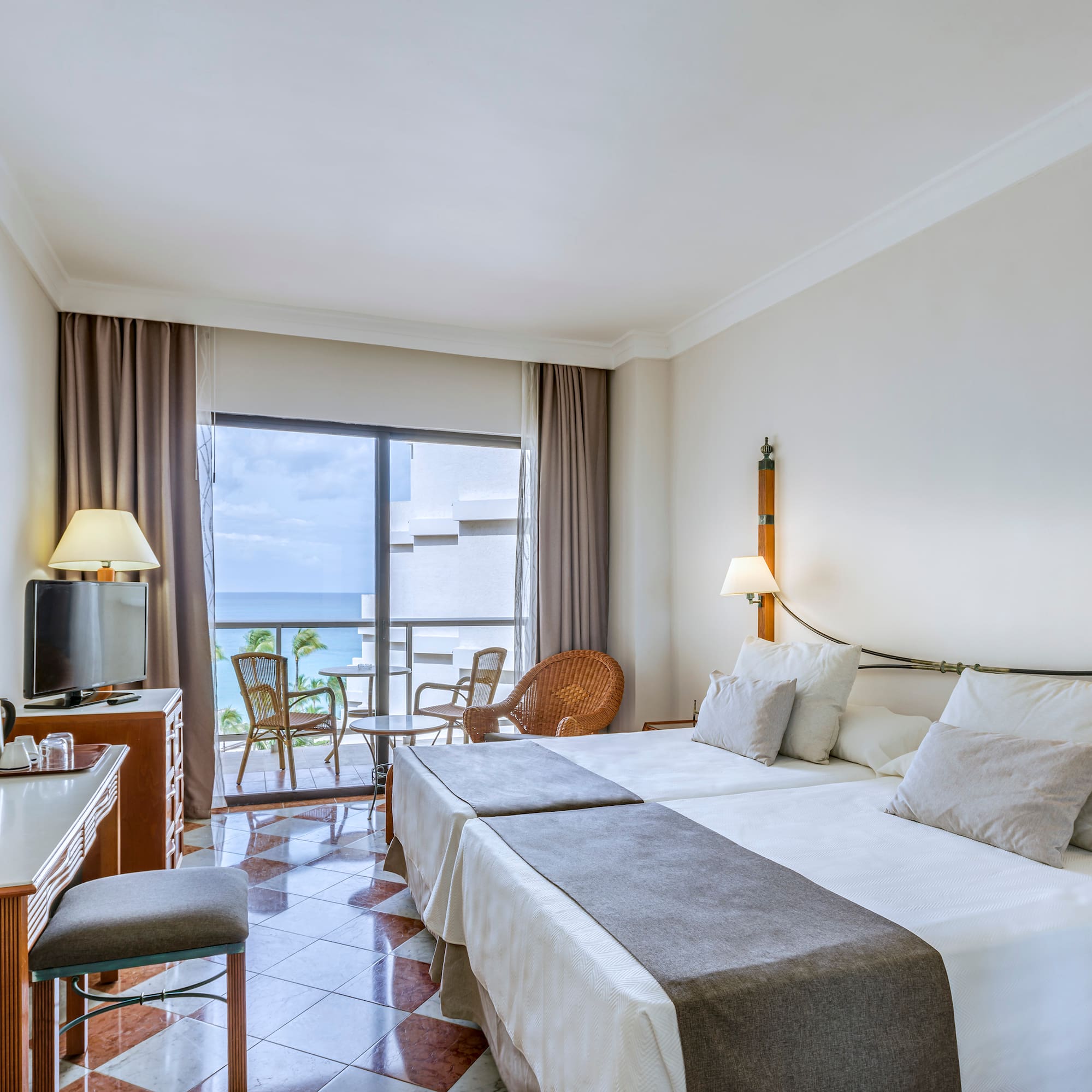 a room with a bed and a table and chairs