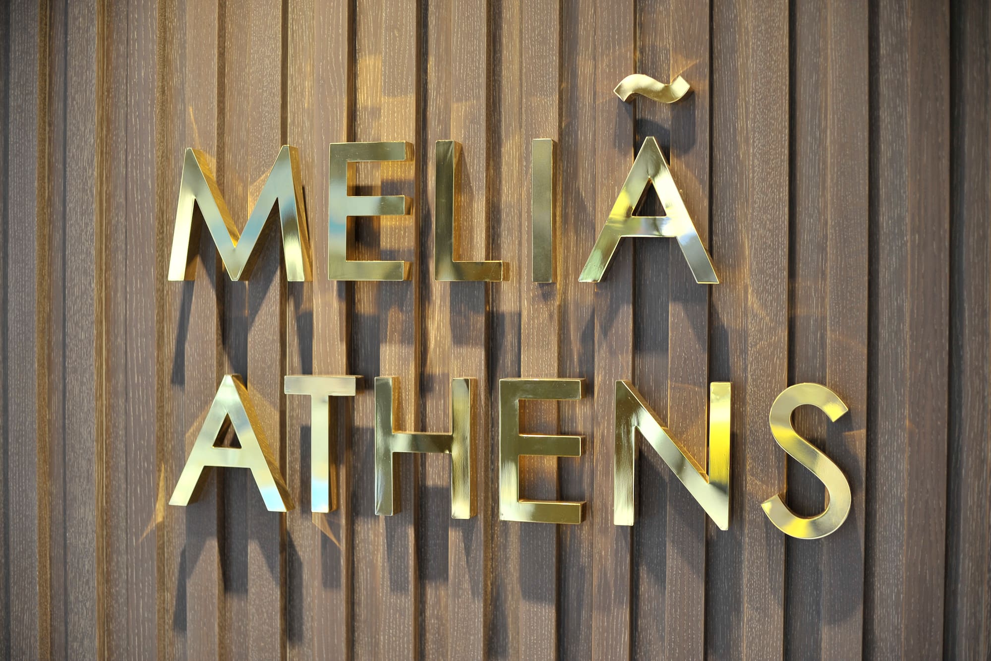 a gold letters on a wood surface