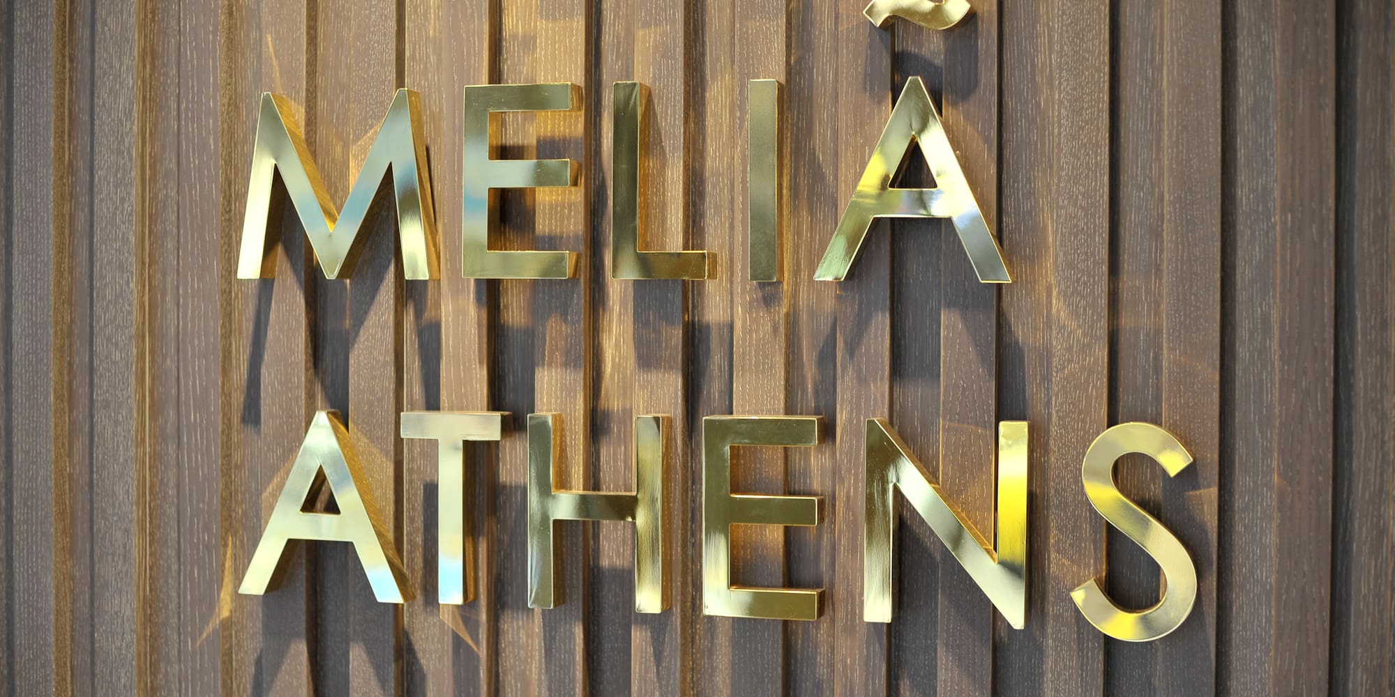 a gold letters on a wood surface