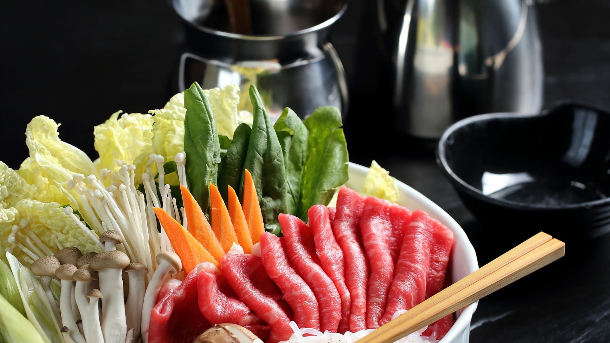 a bowl of raw meat and vegetables