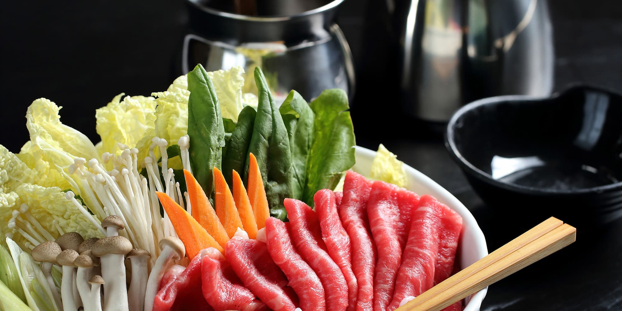 a bowl of raw meat and vegetables