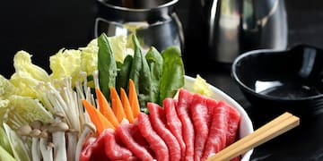 a bowl of raw meat and vegetables
