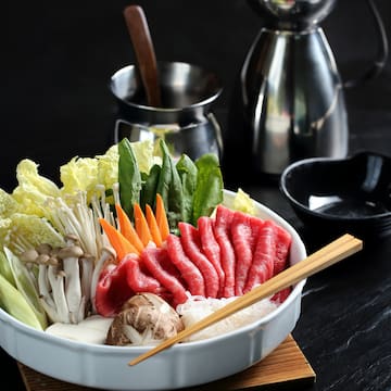a bowl of raw meat and vegetables