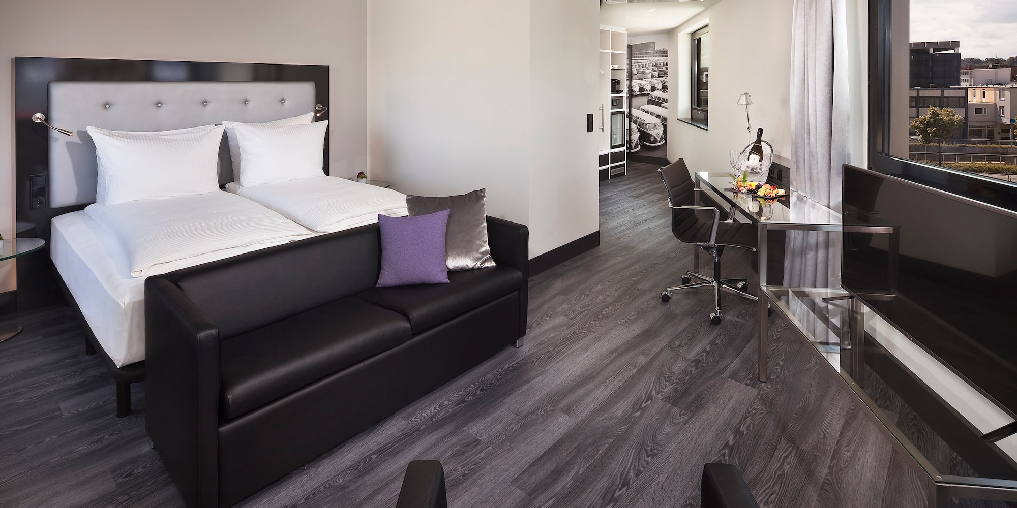 a room with a bed and a desk