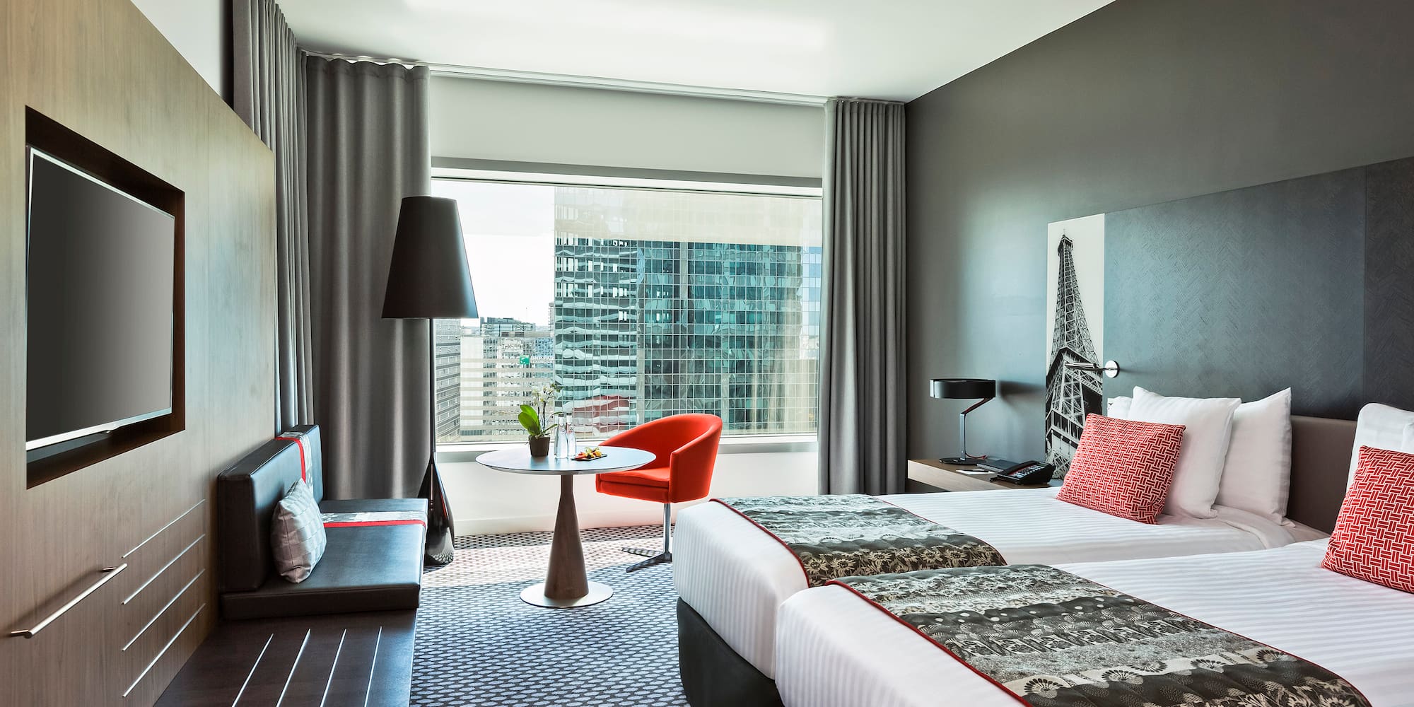 a room with two beds and a table