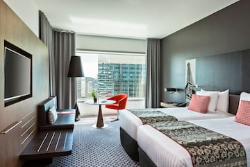 a room with two beds and a table