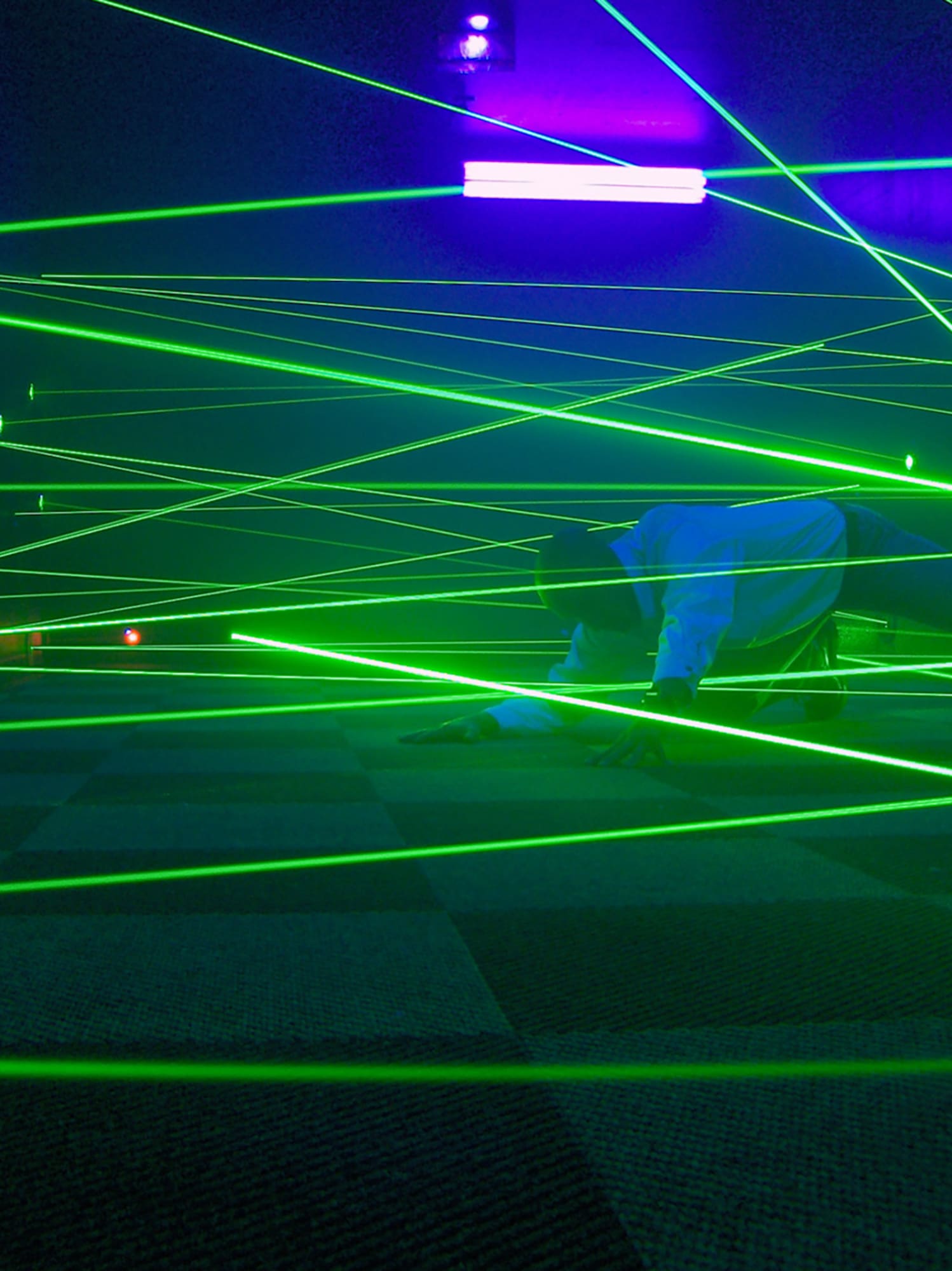 a person lying on the floor with green lights
