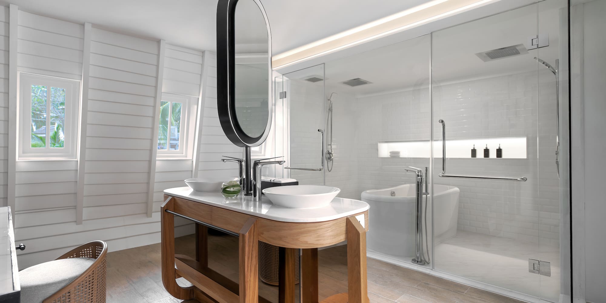 a bathroom with a large glass shower and a sink