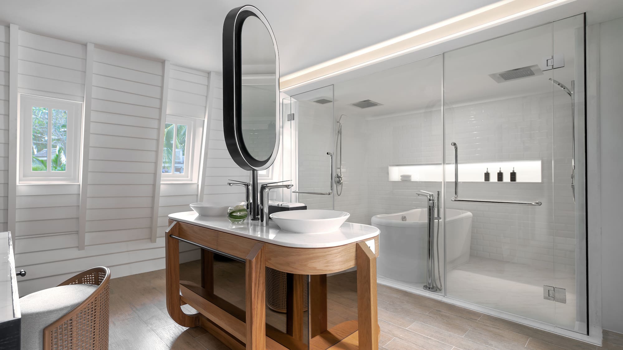 a bathroom with a large glass shower and a sink