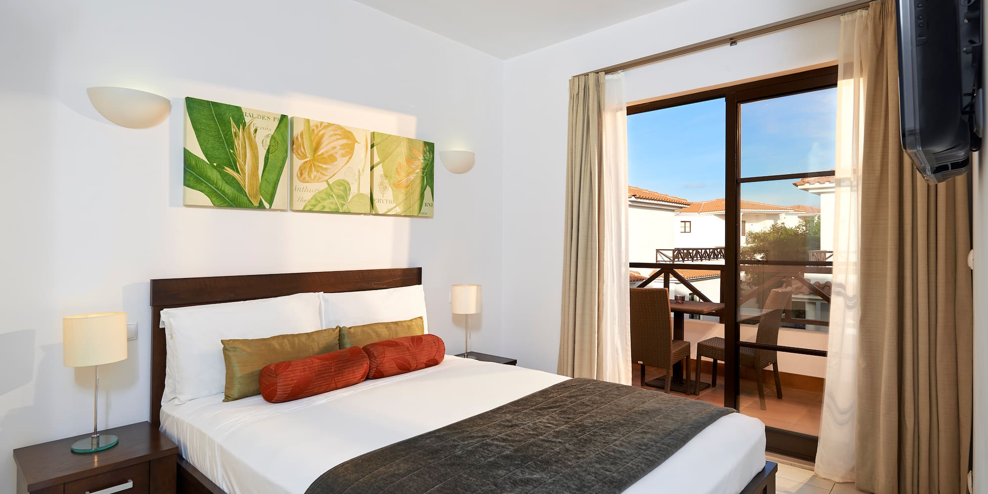 a bedroom with a bed and a glass door