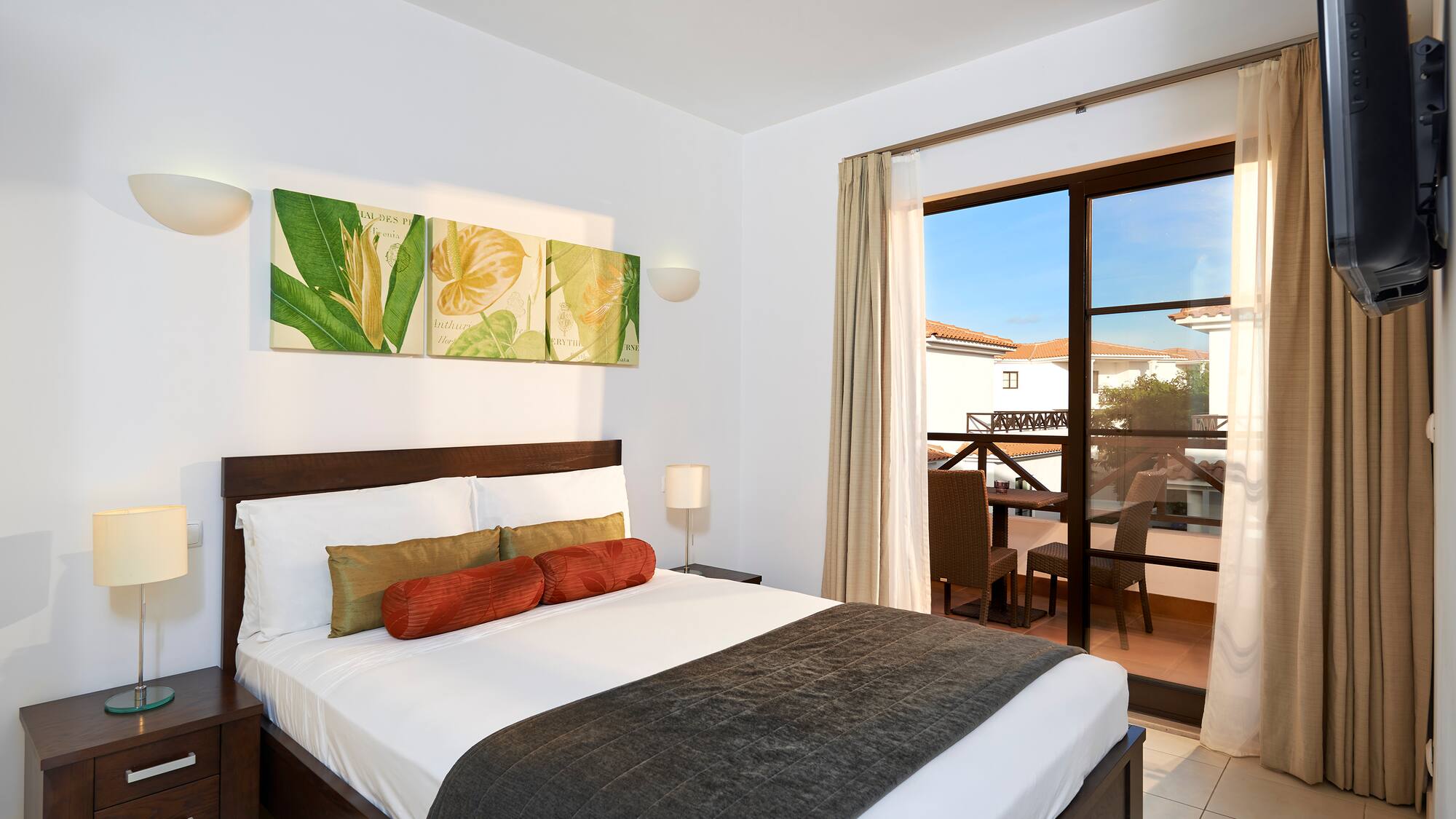 a bedroom with a bed and a glass door