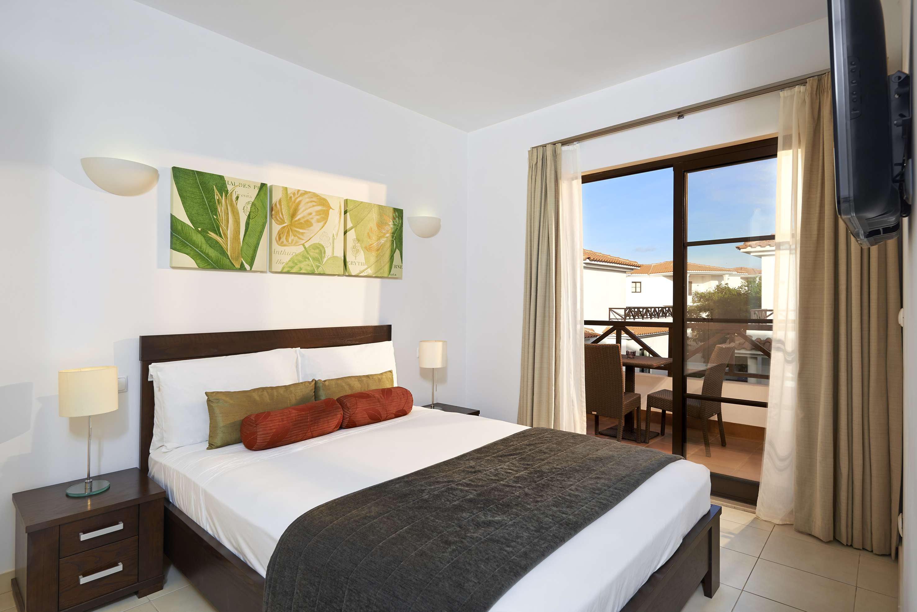a bedroom with a bed and a glass door