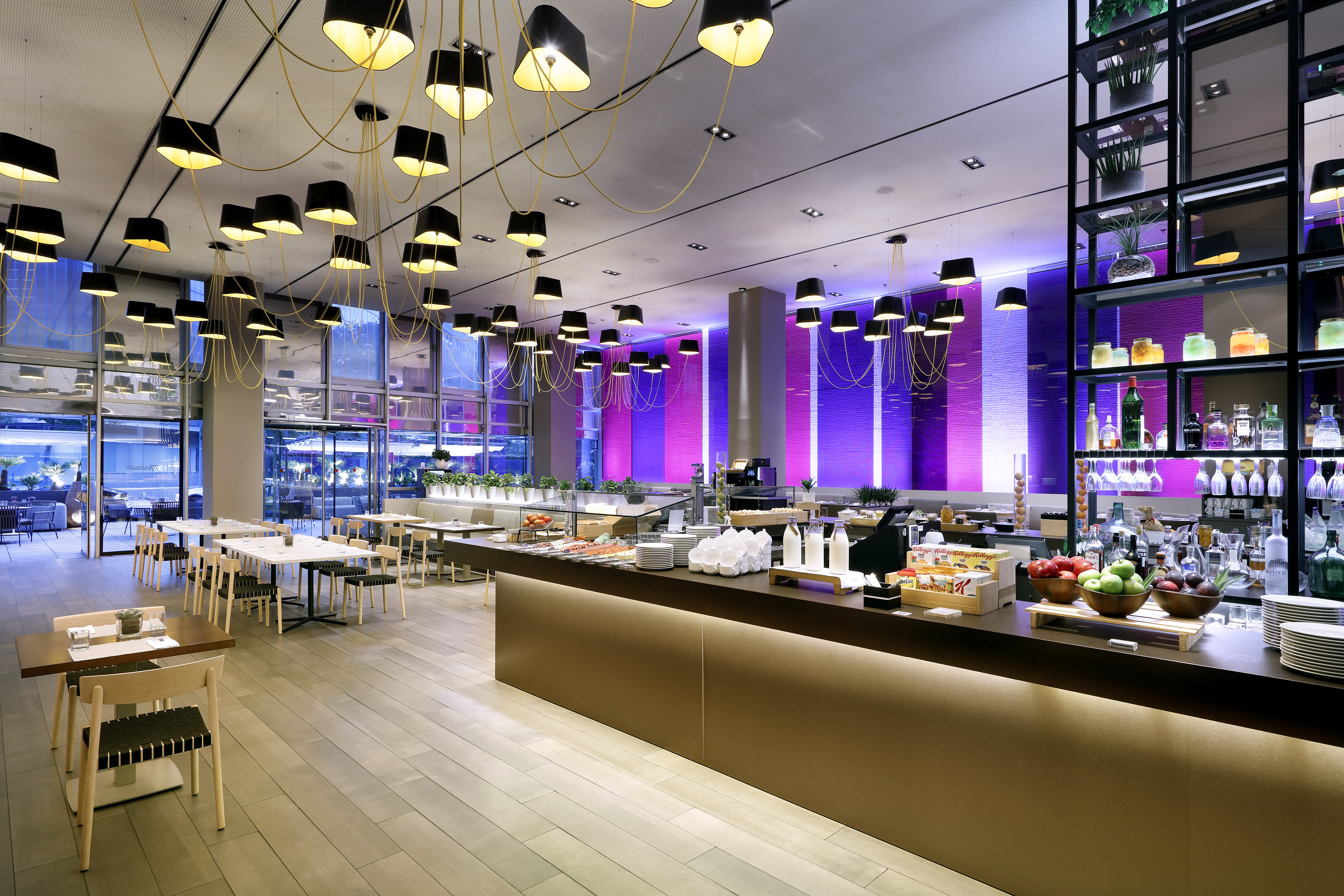 Contemporary hotel buffet restaurant with stylish lamps and purple accent lighting.