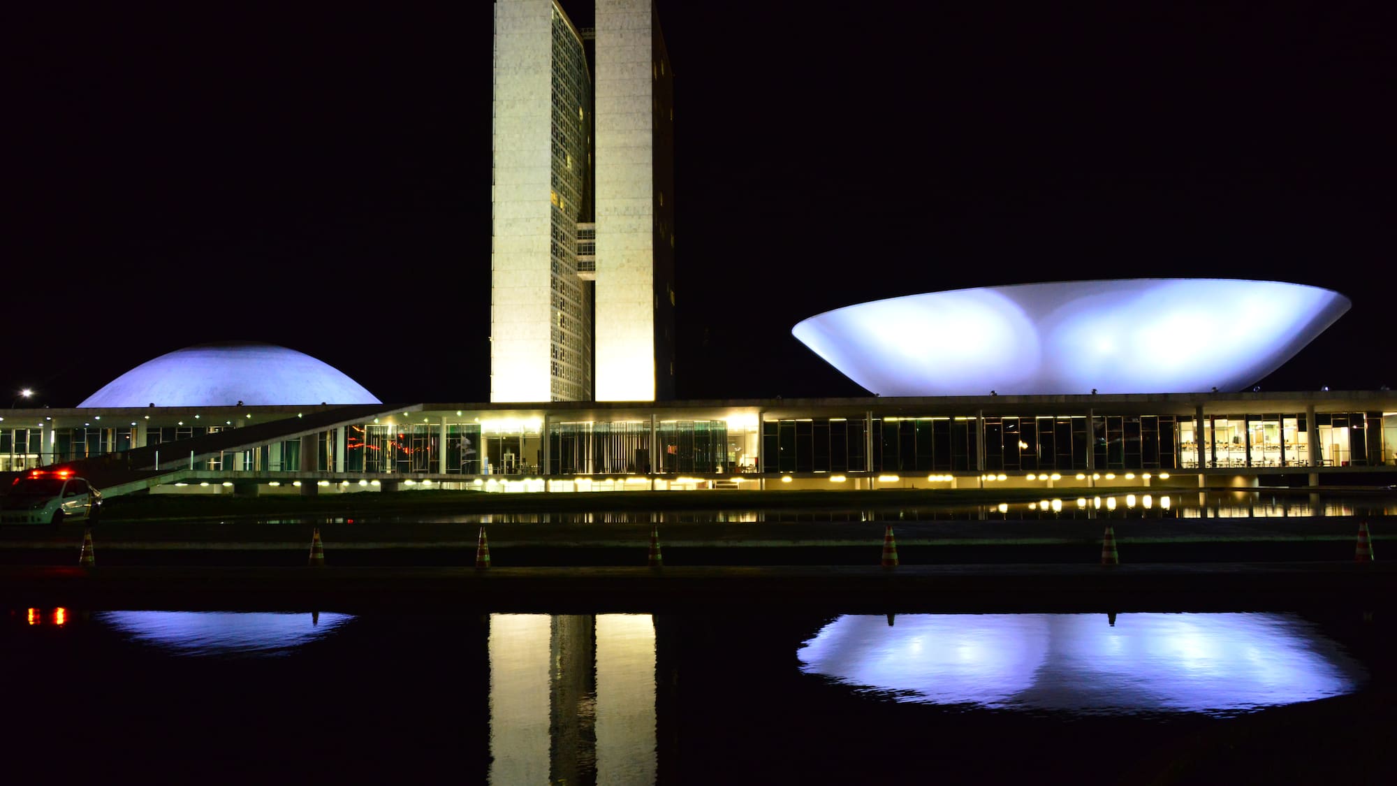 a building with a large white dome and a white bowl on the side