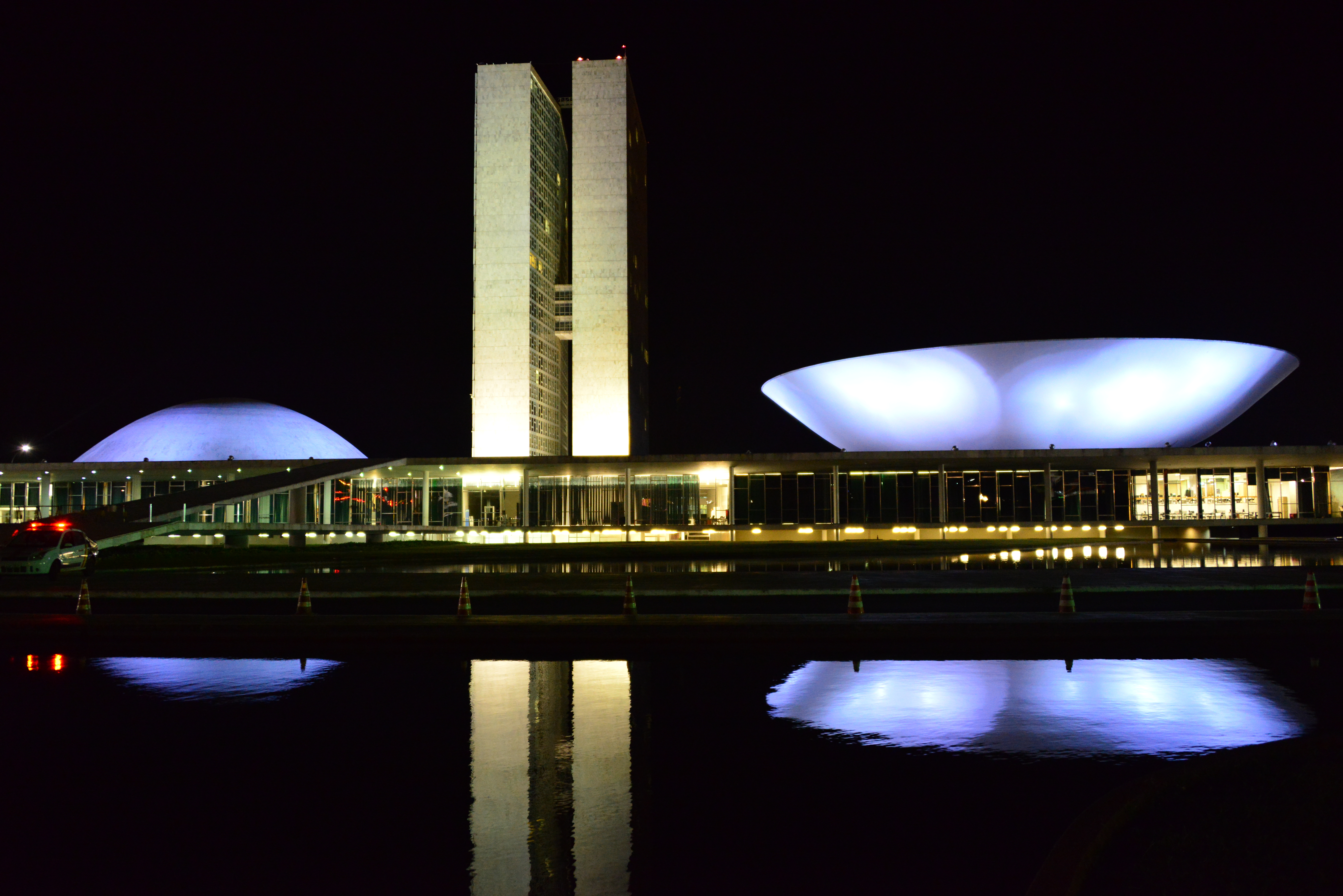a building with a large white dome and a white bowl on the side