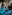 Turquoise water in a cenote cave with stalactites and clear reflections.