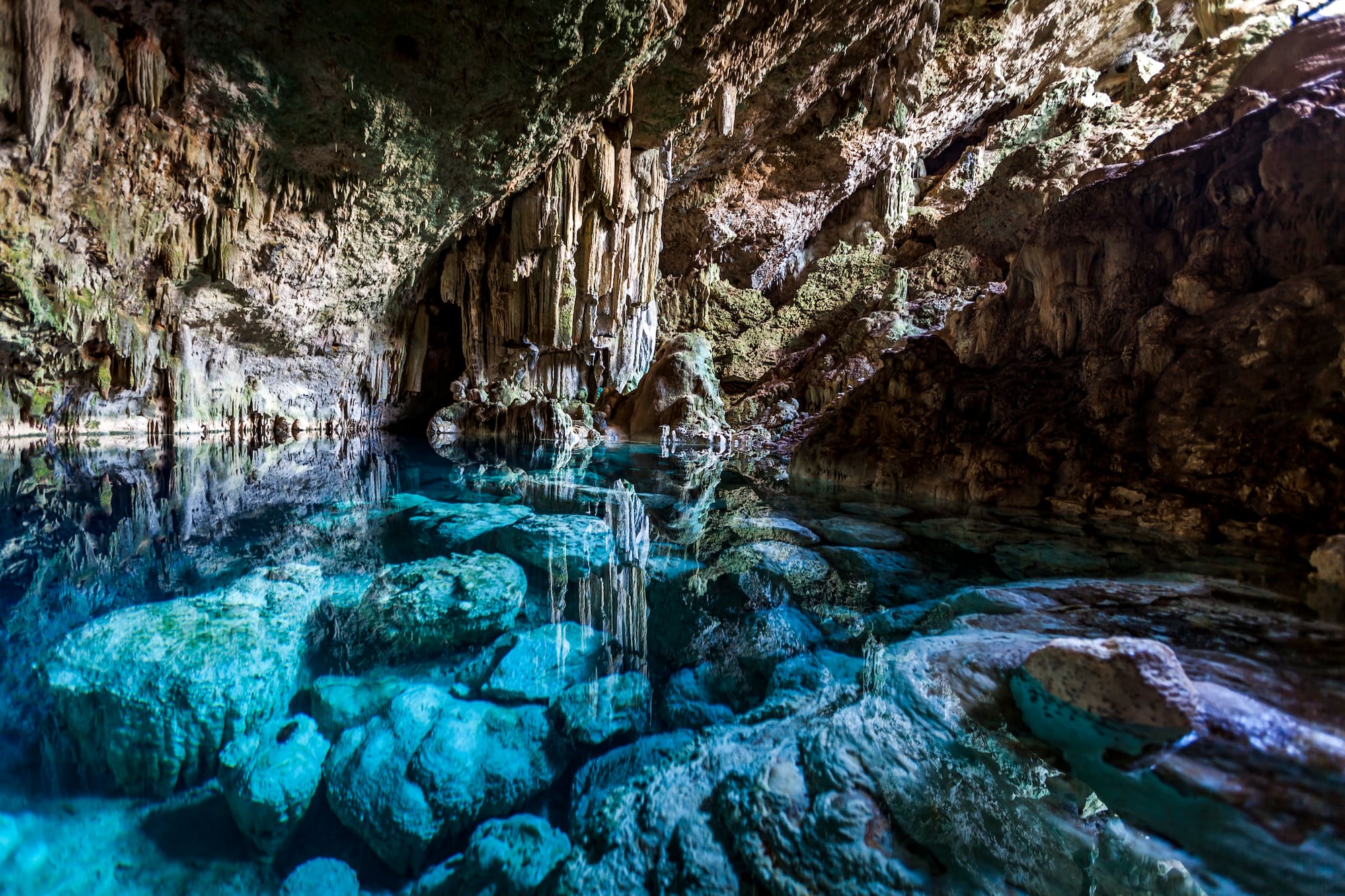 a cave with clear blue water