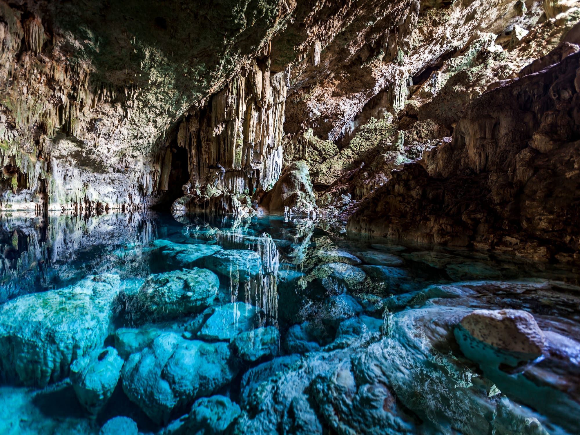 a cave with clear blue water