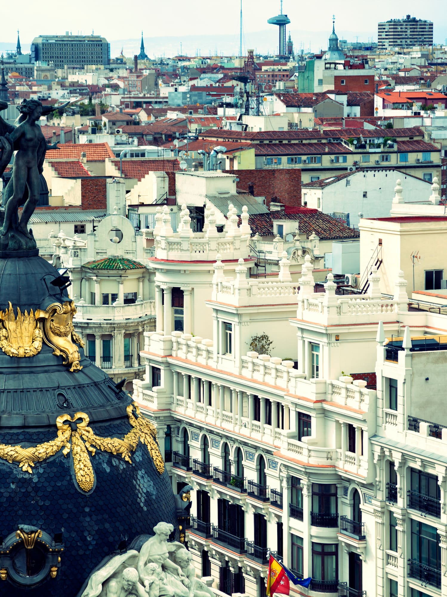 a city with a statue on top of a dome