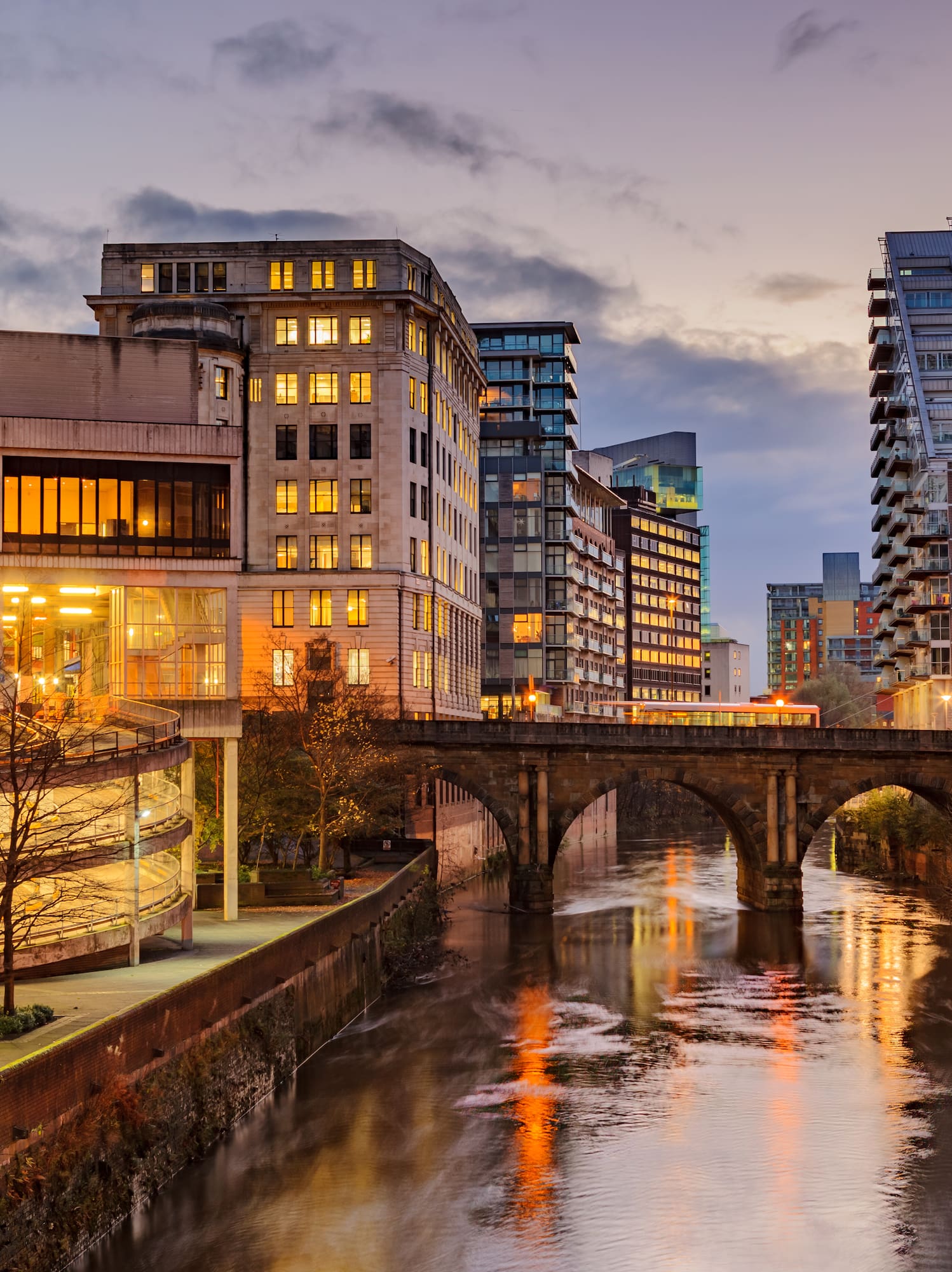 a river with buildings and a bridge