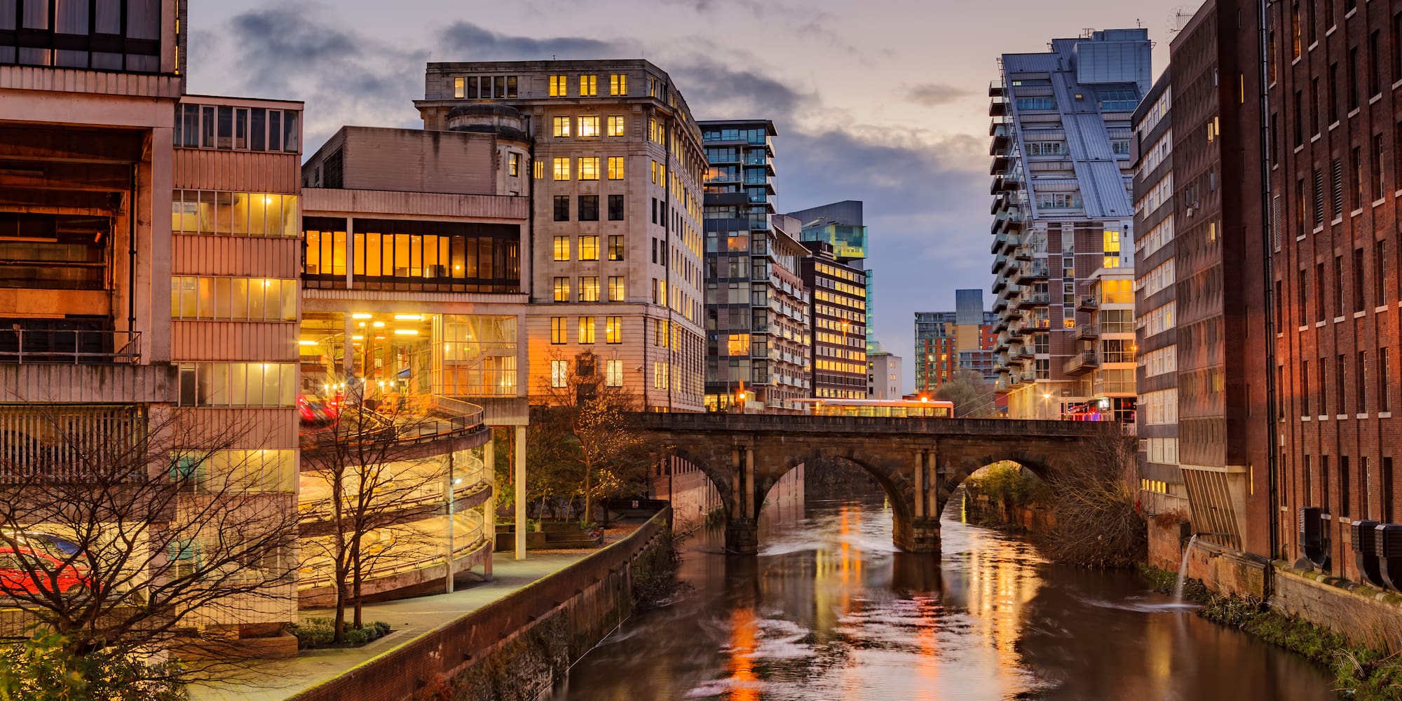 a river with buildings and a bridge