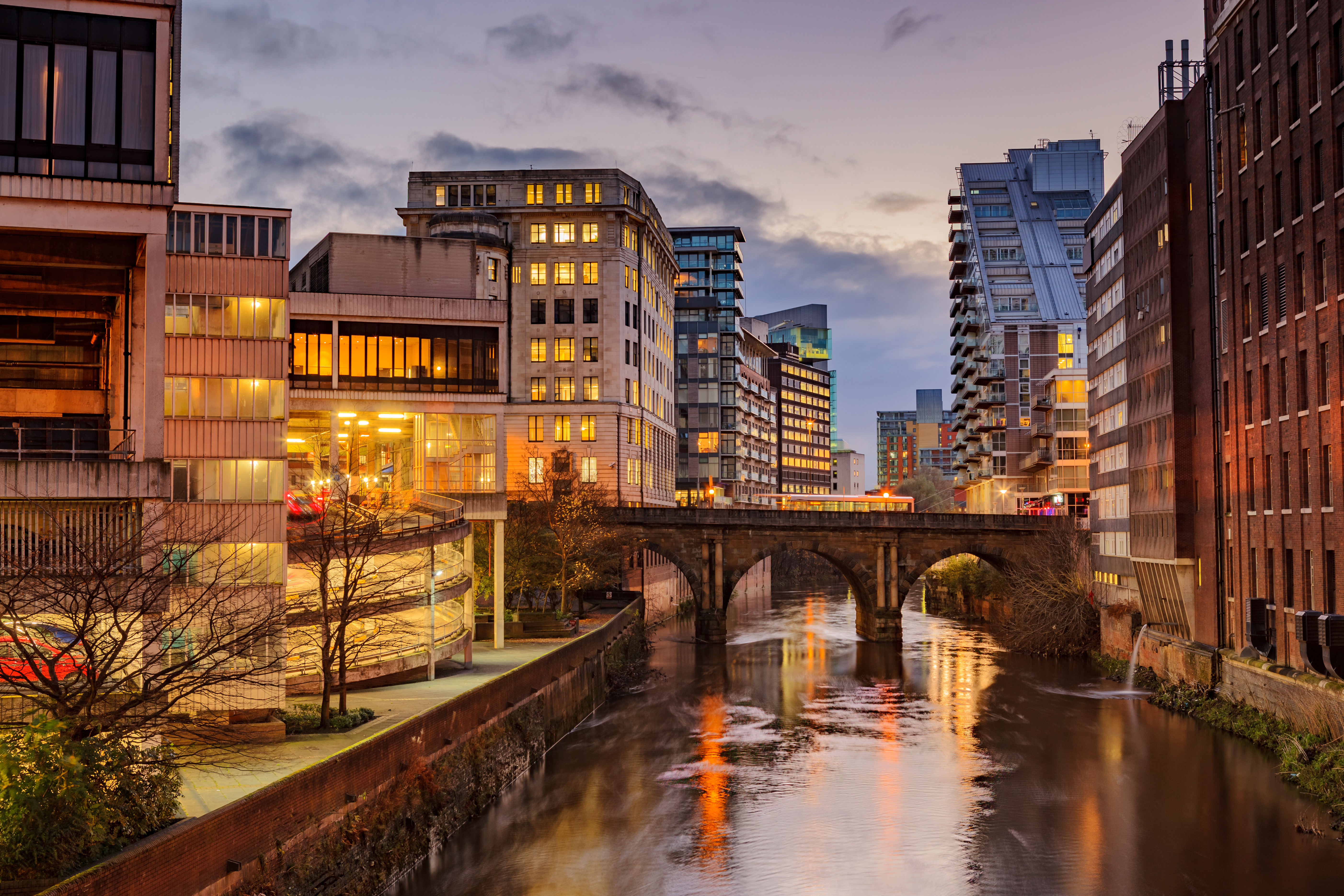 a river with buildings and a bridge