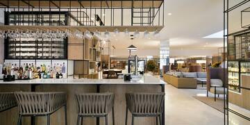 a bar with chairs and a bar stools