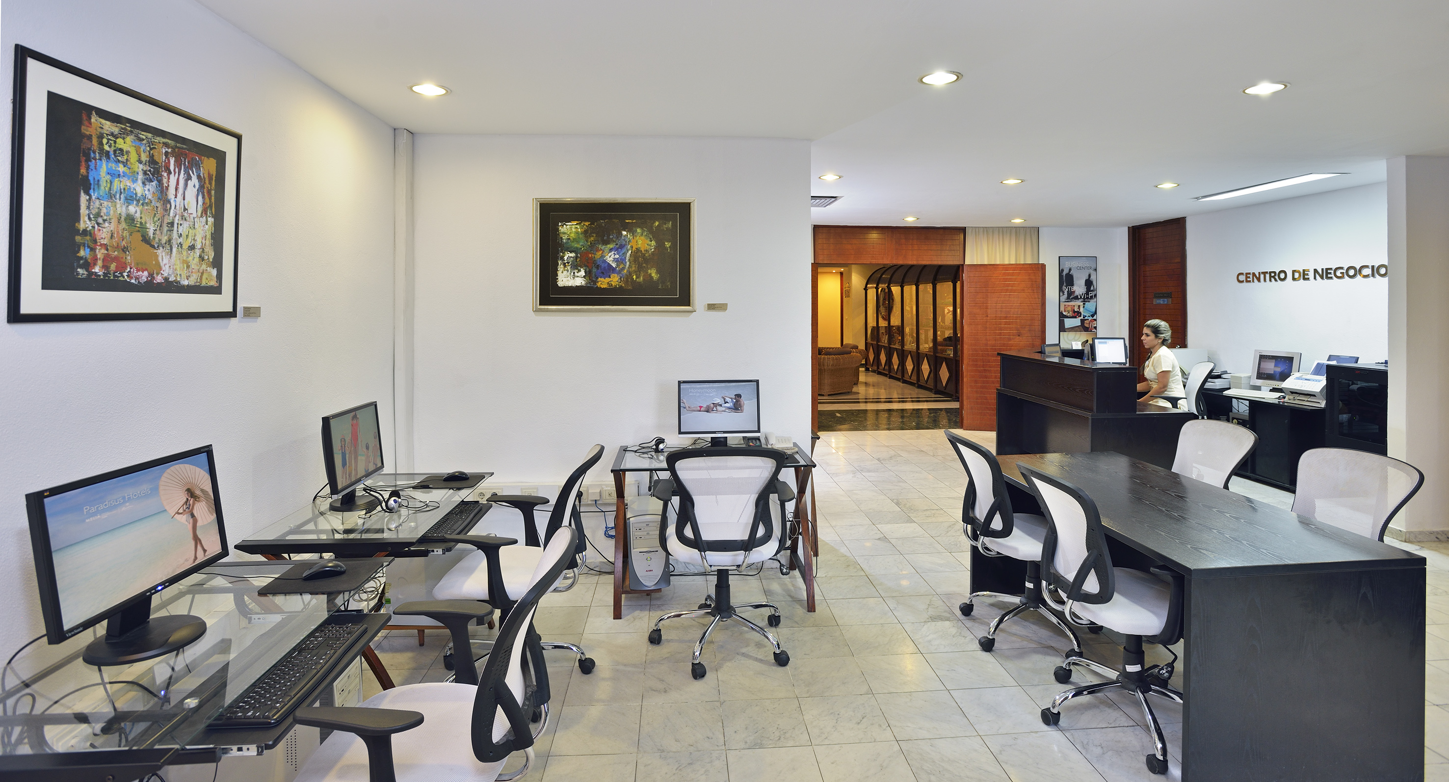 a room with computers and chairs