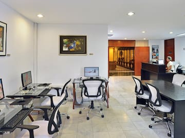 a room with computers and chairs