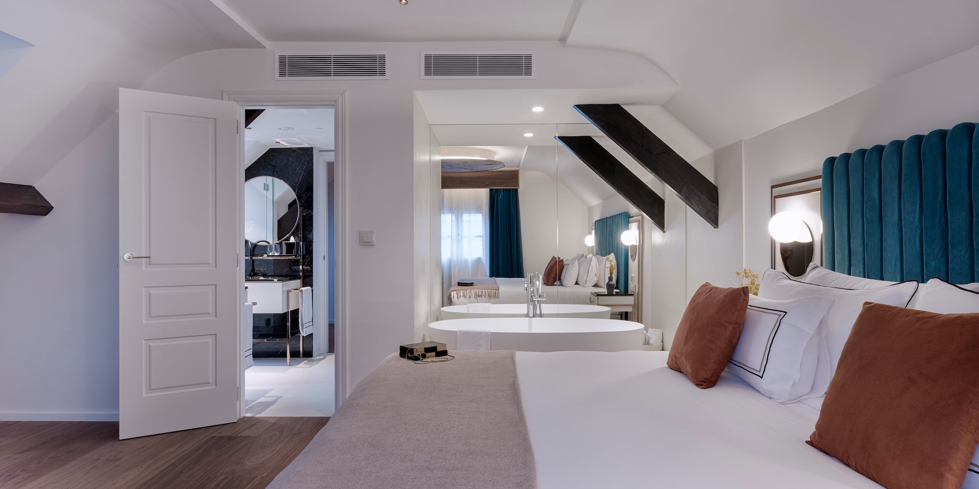 a bedroom with a mirror and a bed
