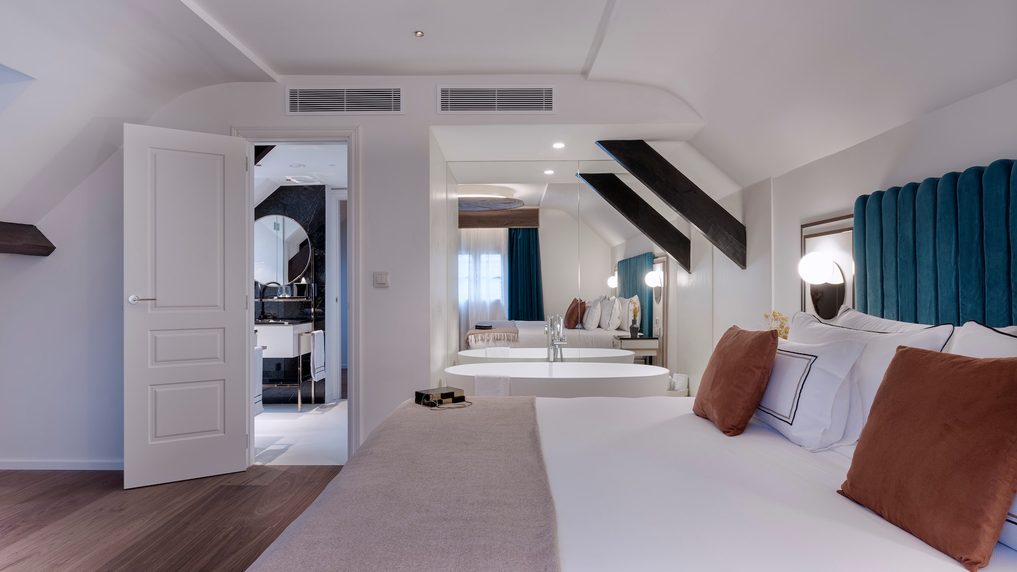 a bedroom with a mirror and a bed