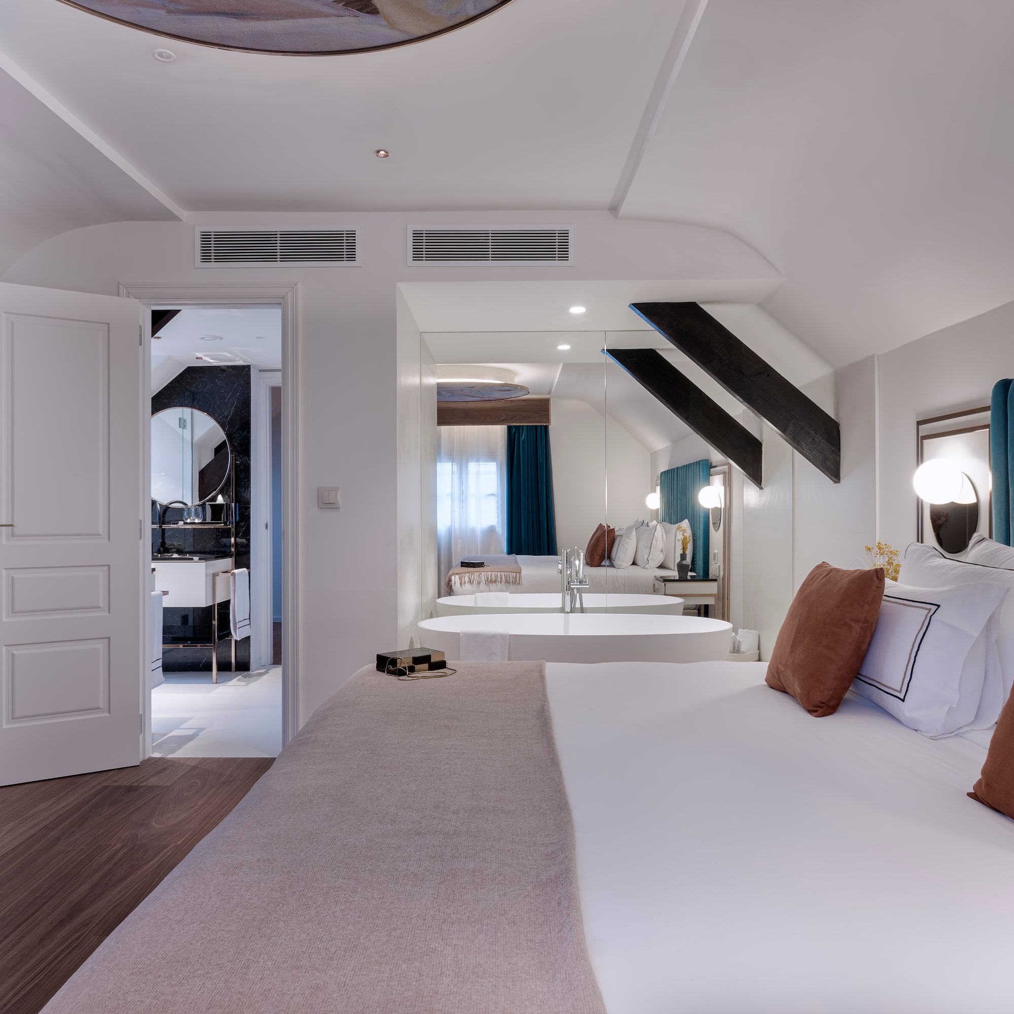 a bedroom with a mirror and a bed