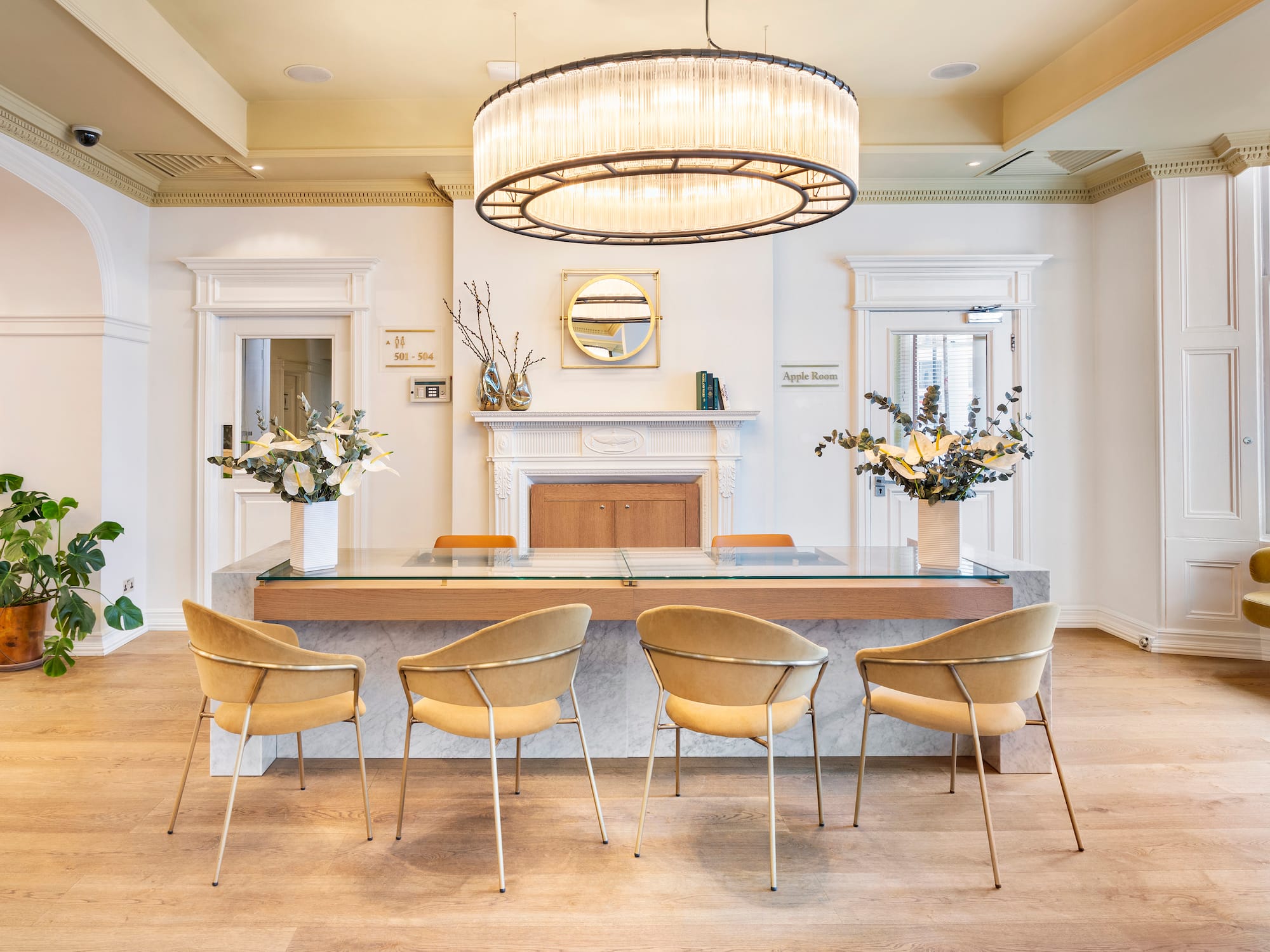 a room with a chandelier and chairs