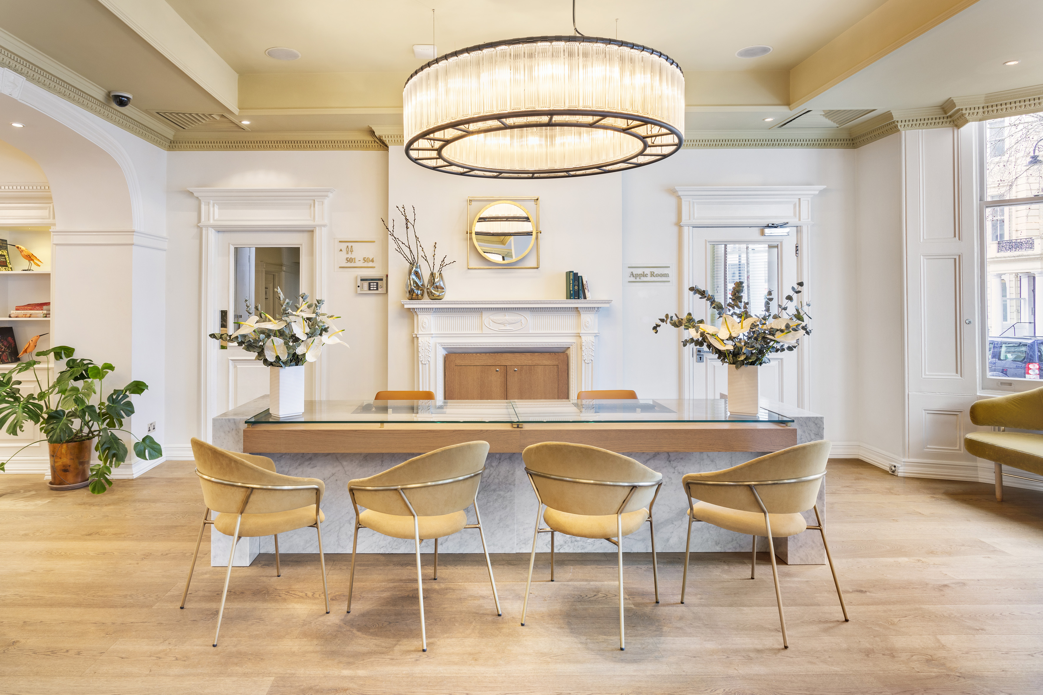 a room with a chandelier and chairs