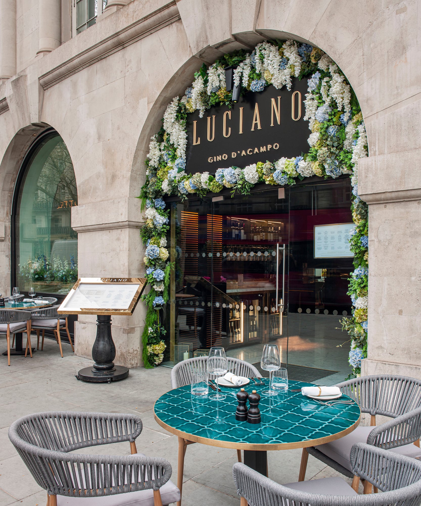 a restaurant with tables and chairs in front of a building