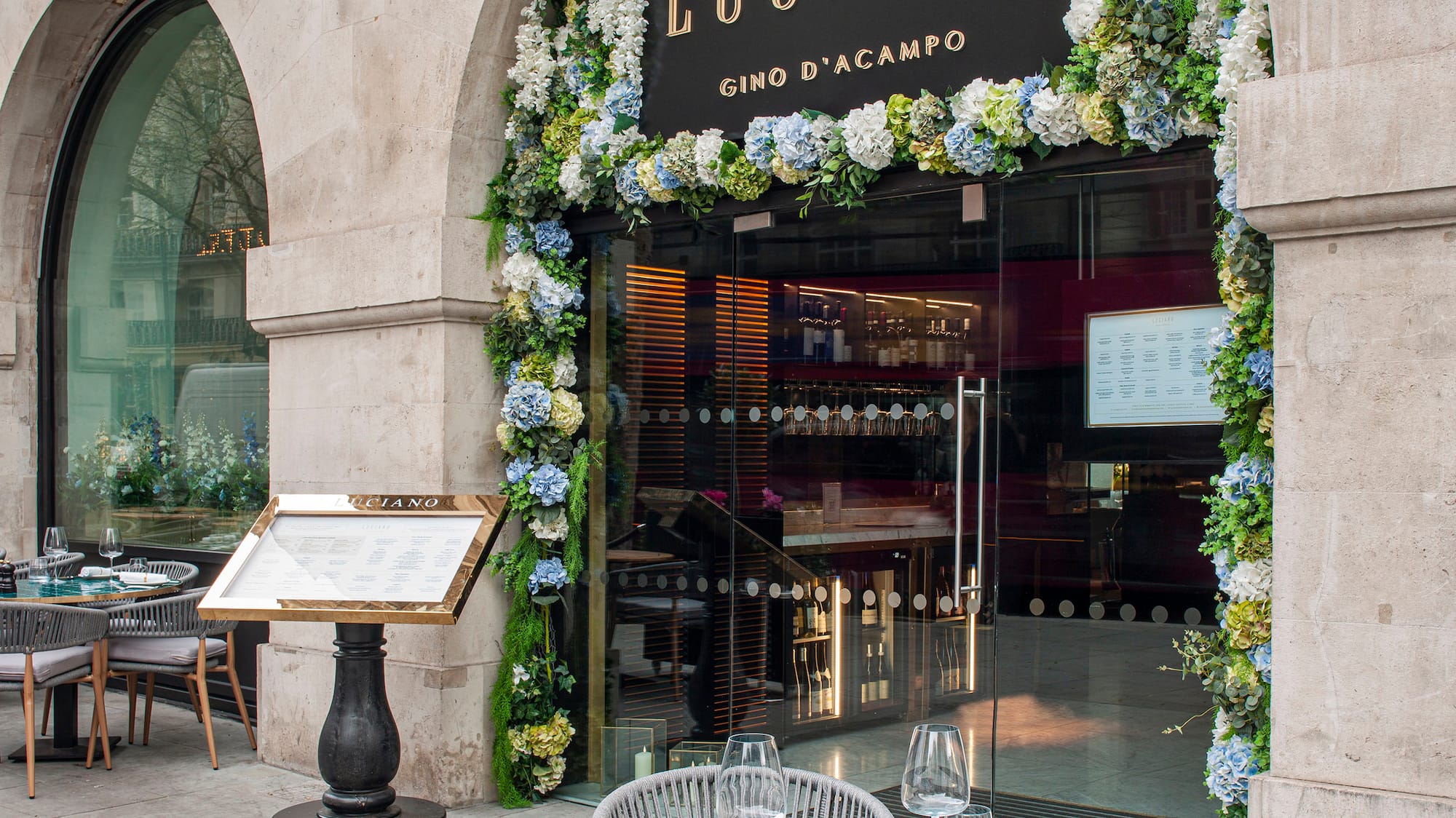 a restaurant with tables and chairs in front of a building