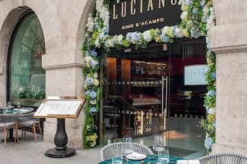 A restaurant featuring tables and chairs outside a building.